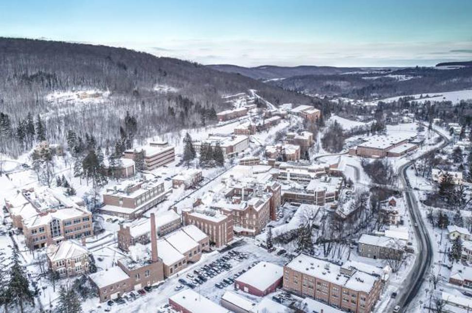 Drone view of Alfred University with snow on covering campus