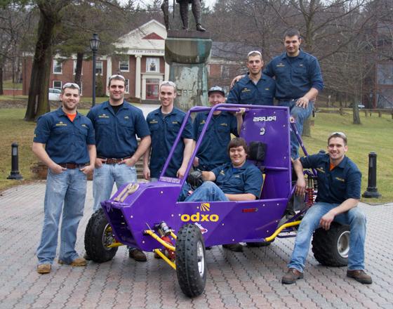Group of students with the Baja Car